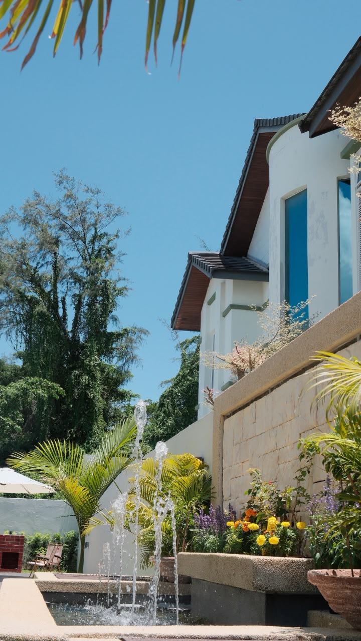 Side of the house with fountain and garden